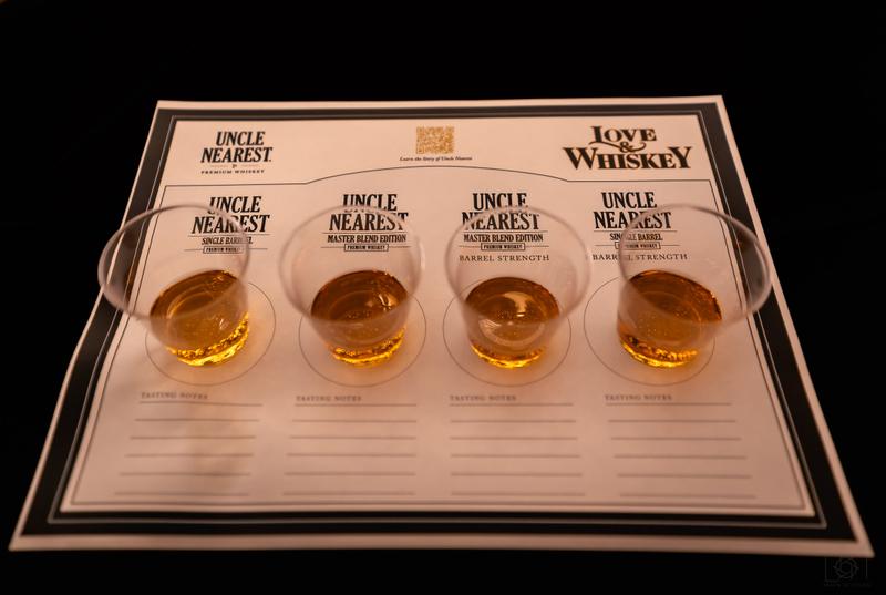 Two small glasses of Uncle Nearest whiskey placed on a printed tasting mat.